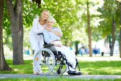 elderly woman in a wheelchair with her caregiver